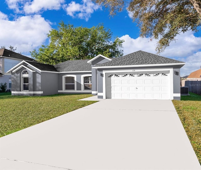 ranch-style house featuring a garage, a front lawn, and stucco siding