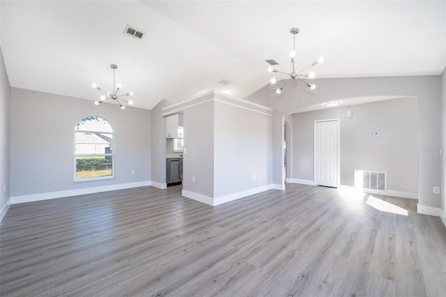 unfurnished living room with arched walkways, vaulted ceiling, visible vents, and a notable chandelier