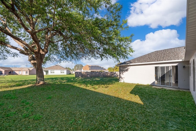 view of yard featuring a residential view and fence