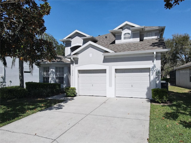 view of front of home featuring stucco siding, a shingled roof, concrete driveway, an attached garage, and a front lawn