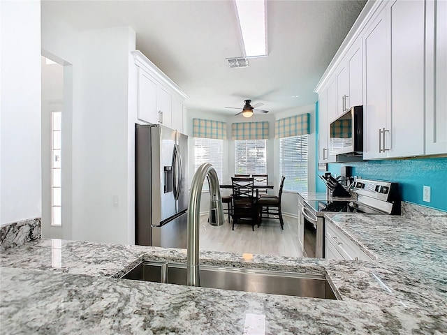 kitchen with white cabinetry and stainless steel appliances