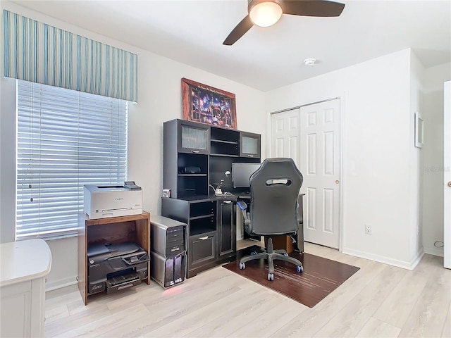 office with light wood-type flooring, ceiling fan, and baseboards