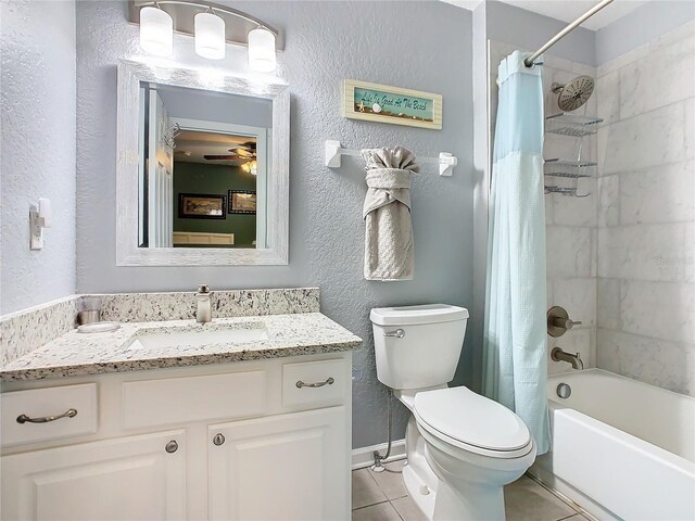 bathroom with a textured wall, shower / bathtub combination with curtain, toilet, vanity, and tile patterned flooring