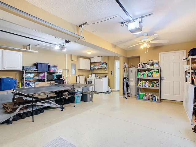 garage with water heater, washing machine and dryer, electric panel, and a garage door opener