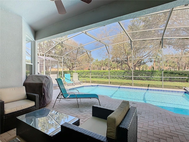 view of swimming pool featuring a fenced in pool, a patio, an outdoor hangout area, a ceiling fan, and glass enclosure