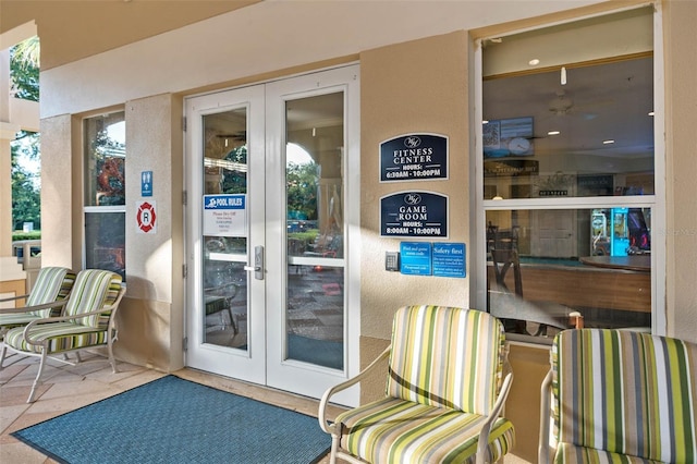 entrance to property with french doors and stucco siding