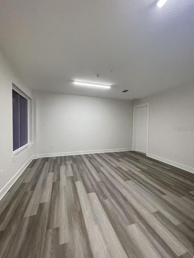 empty room with hardwood / wood-style flooring