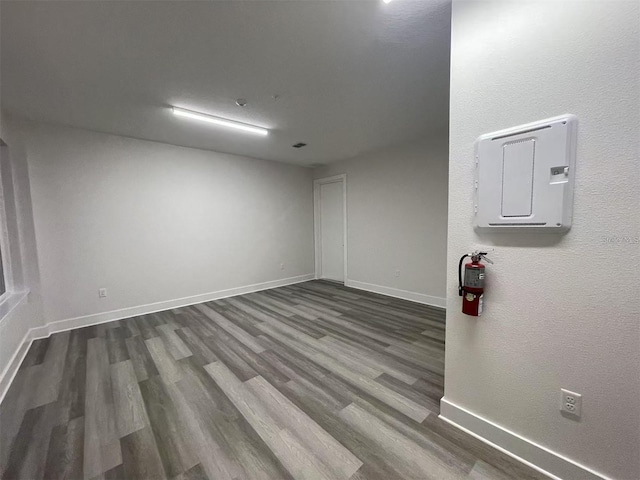 empty room with dark hardwood / wood-style flooring