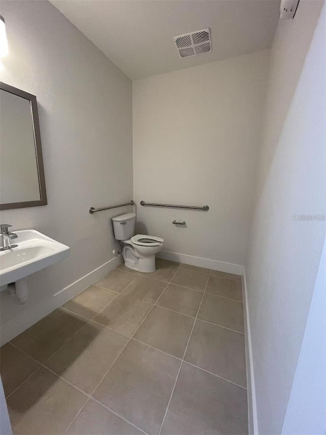 bathroom with tile patterned flooring and toilet