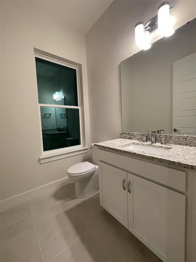 bathroom with tile patterned floors, toilet, and vanity