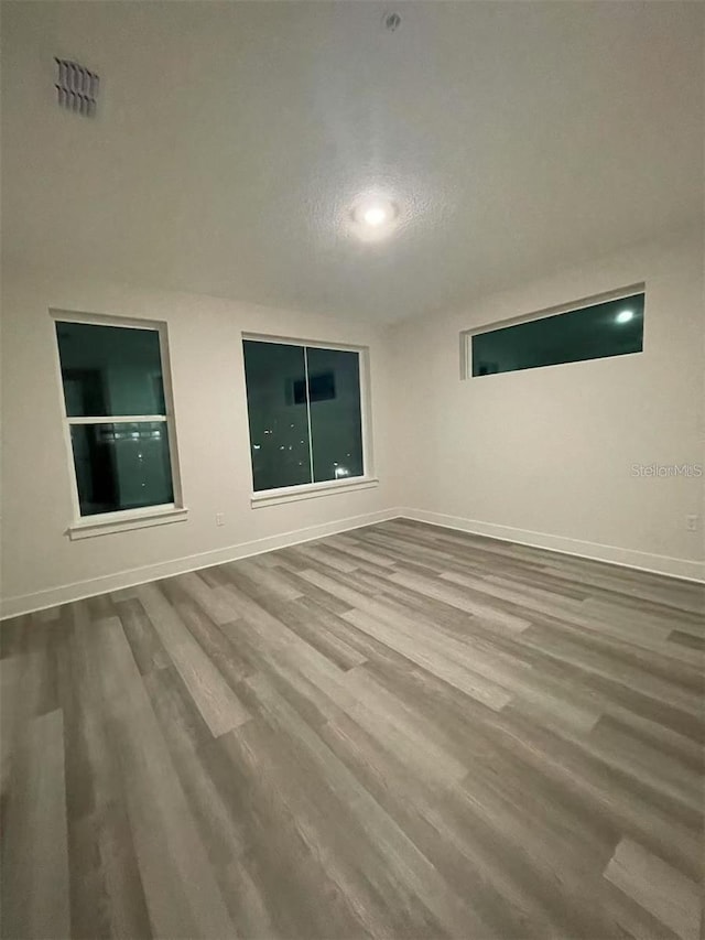 spare room with hardwood / wood-style flooring