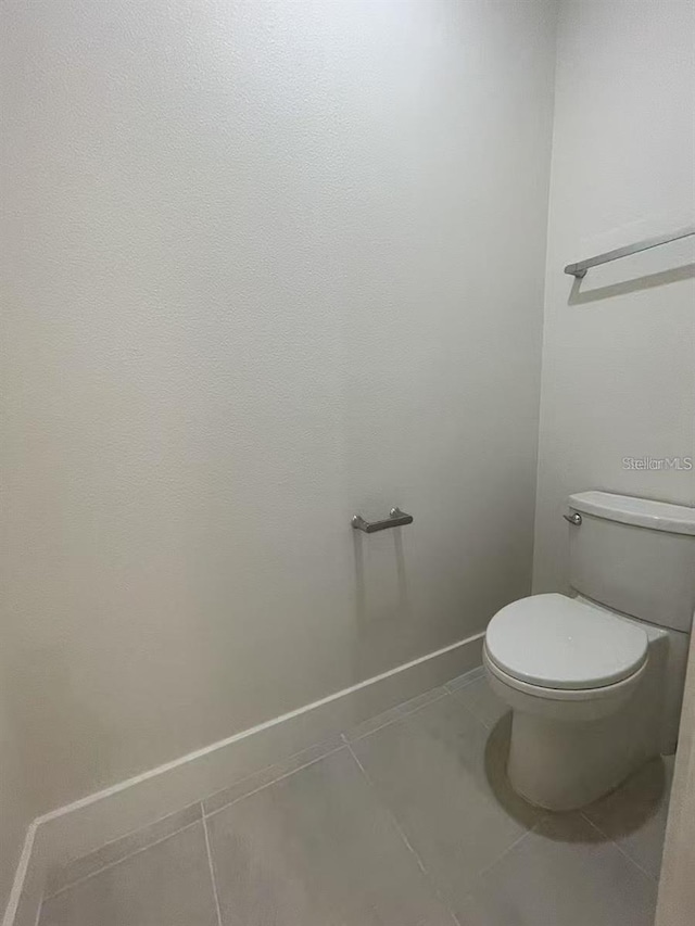 bathroom with tile patterned flooring and toilet