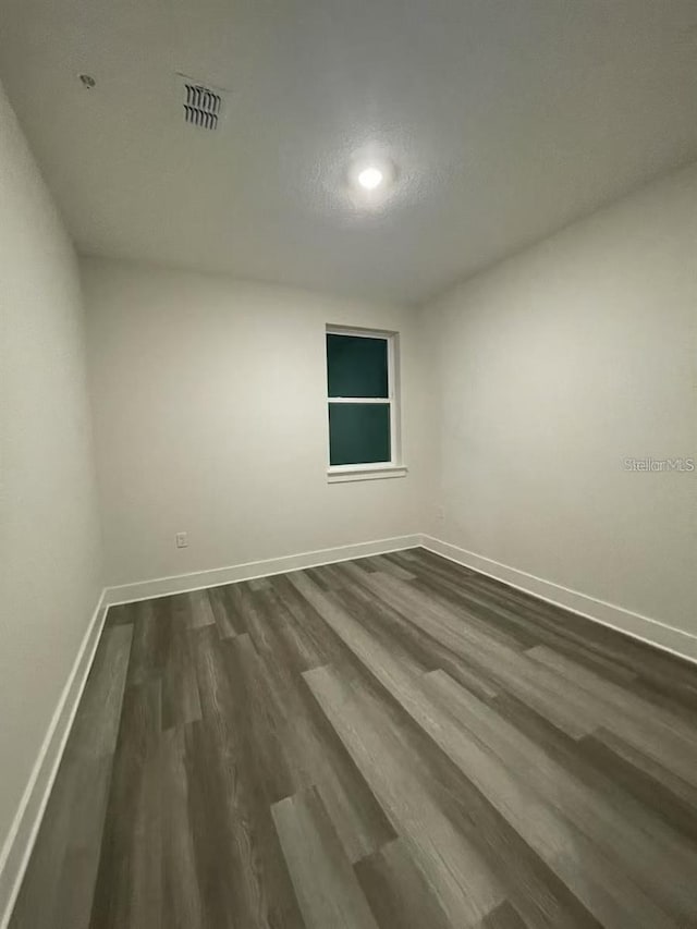 empty room featuring dark hardwood / wood-style floors