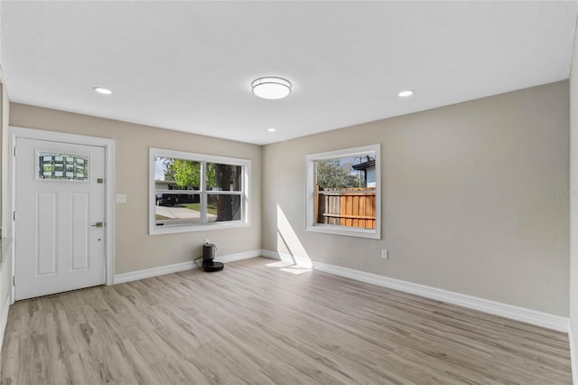 entrance foyer with light wood finished floors, baseboards, and recessed lighting