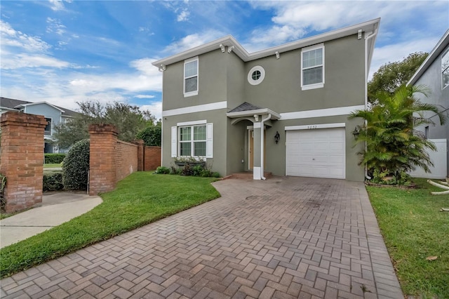 view of front of property with an attached garage, a front yard, decorative driveway, and stucco siding