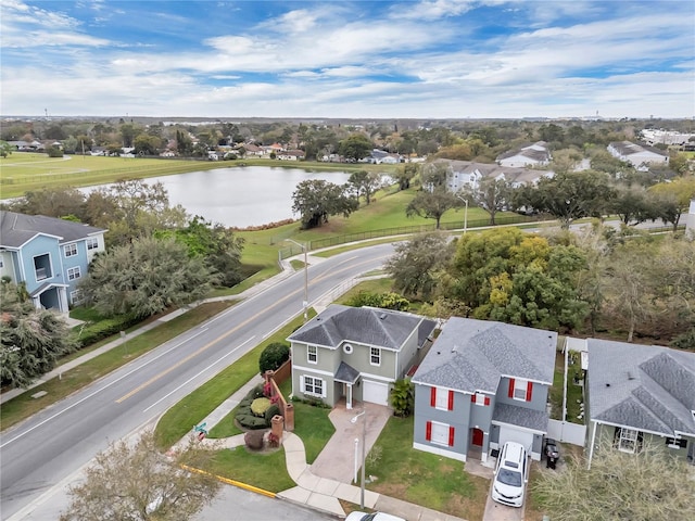 drone / aerial view with a water view and a residential view