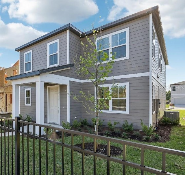 view of front of house featuring cooling unit and fence