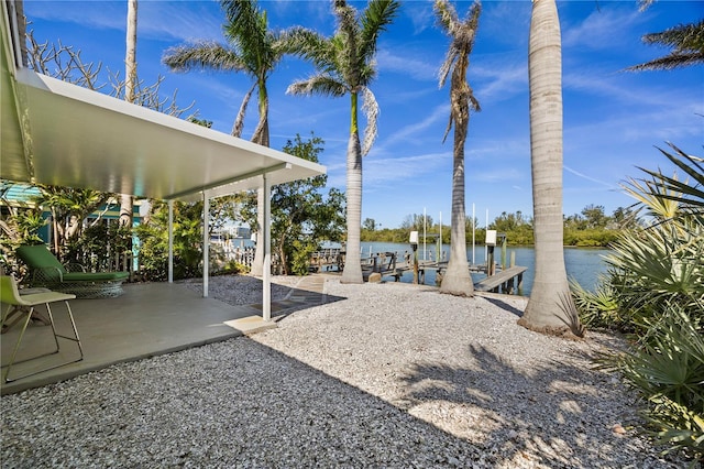 exterior space with a dock and a water view