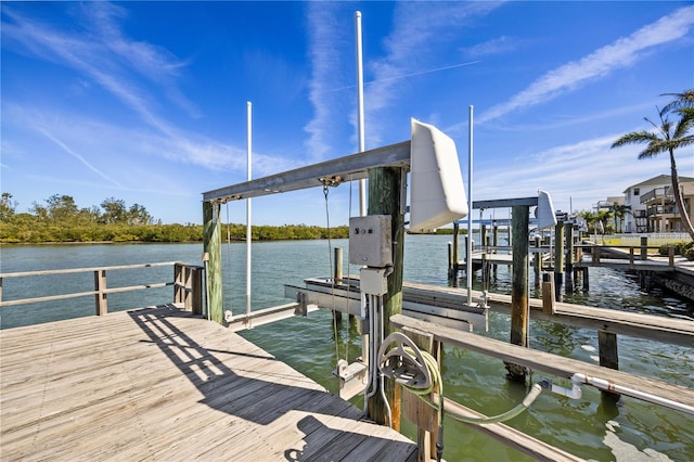 dock area with a water view and boat lift