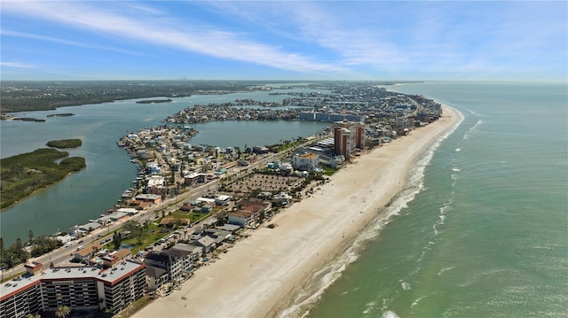 aerial view with a city view, a water view, and a beach view