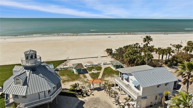 drone / aerial view with a water view and a beach view