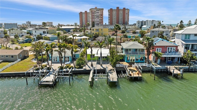 view of dock with a water view and a view of city