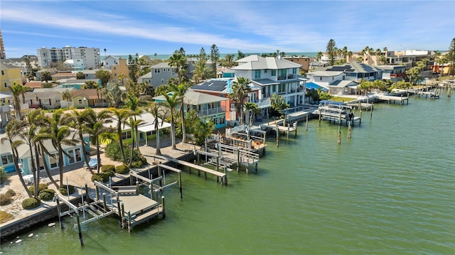 view of dock featuring a water view, boat lift, and a residential view