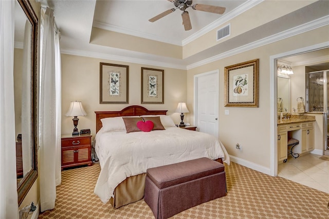 bedroom featuring light carpet, visible vents, baseboards, ornamental molding, and a tray ceiling