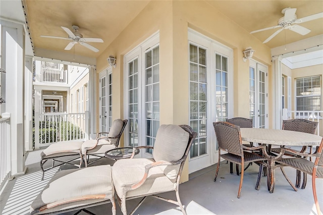 sunroom with ceiling fan and french doors