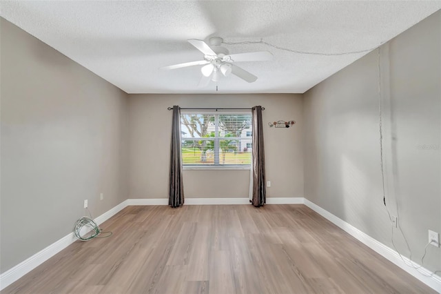 unfurnished room with light wood-type flooring, a textured ceiling, and ceiling fan