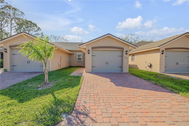 ranch-style home with an attached garage, decorative driveway, and stucco siding