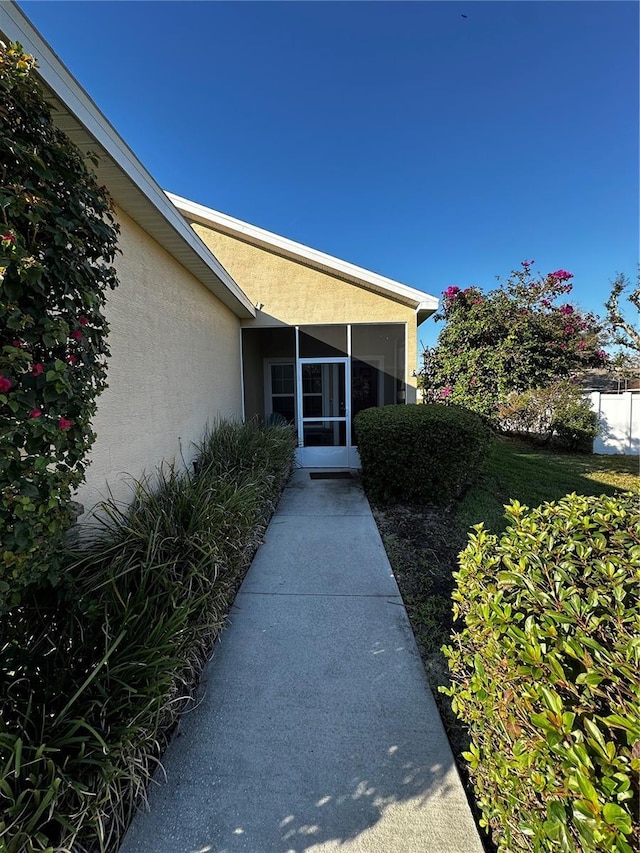 property entrance featuring stucco siding