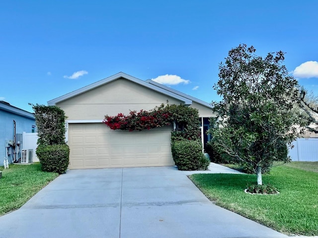 ranch-style house with concrete driveway, a front lawn, central AC unit, and stucco siding