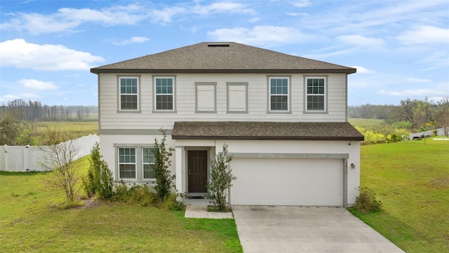 traditional-style home featuring a garage, fence, driveway, roof with shingles, and a front yard