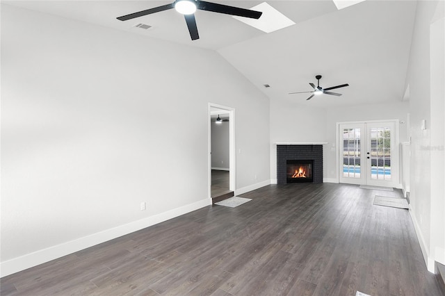 unfurnished living room with dark wood-type flooring, a fireplace, visible vents, and baseboards