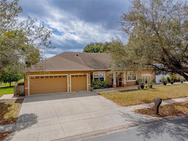 view of front of home with a front yard and a garage