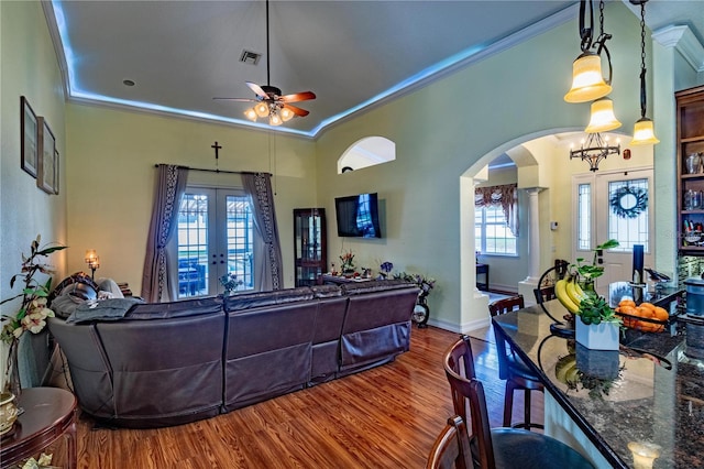 living room with crown molding, french doors, and hardwood / wood-style floors