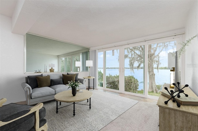 living area with a textured ceiling and tile patterned floors