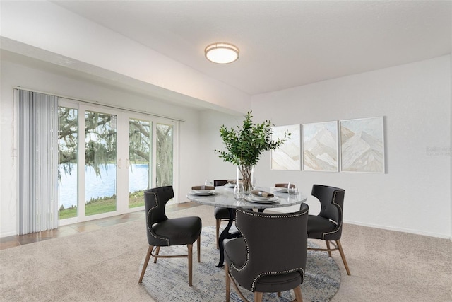 dining area with baseboards, carpet flooring, and french doors