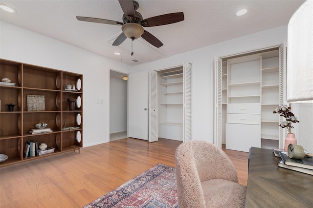 office space featuring wood finished floors, a ceiling fan, and recessed lighting