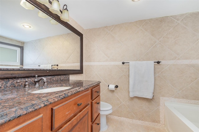 full bath featuring a washtub, tile walls, toilet, vanity, and tile patterned flooring