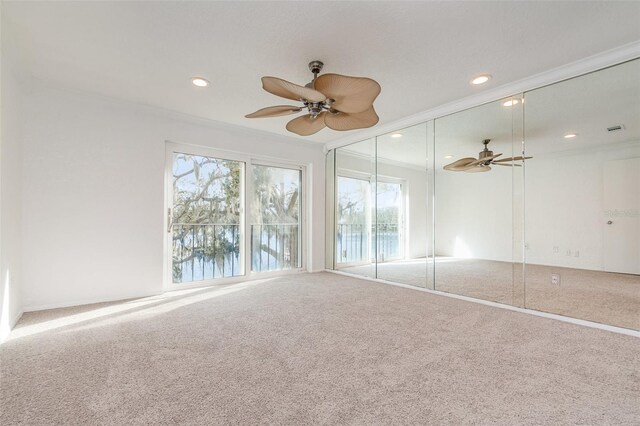 carpeted spare room featuring a ceiling fan, recessed lighting, and visible vents