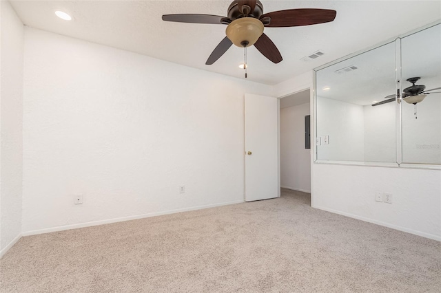 empty room with carpet flooring, visible vents, and baseboards