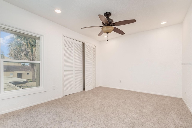 unfurnished bedroom featuring baseboards, a ceiling fan, carpet, a closet, and recessed lighting