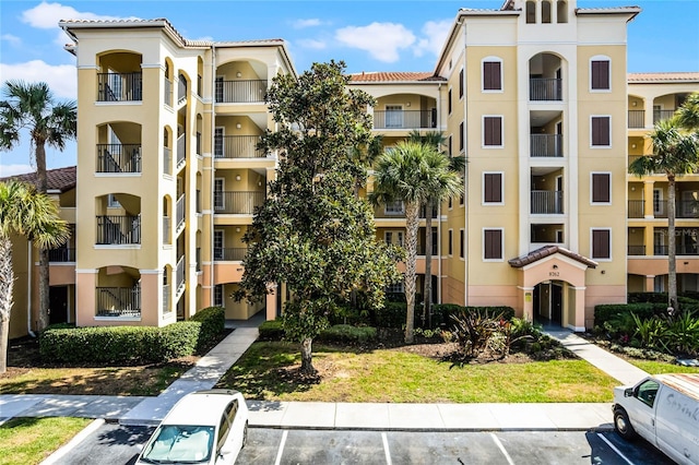 view of property featuring uncovered parking