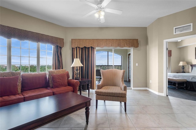 living area featuring light tile patterned floors, plenty of natural light, visible vents, and ceiling fan