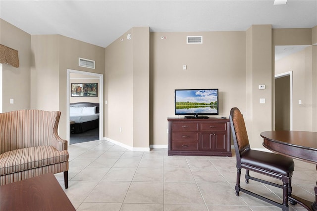 interior space featuring light tile patterned floors, visible vents, and baseboards