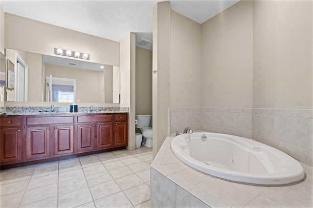 bathroom featuring tile patterned flooring, a sink, toilet, and double vanity