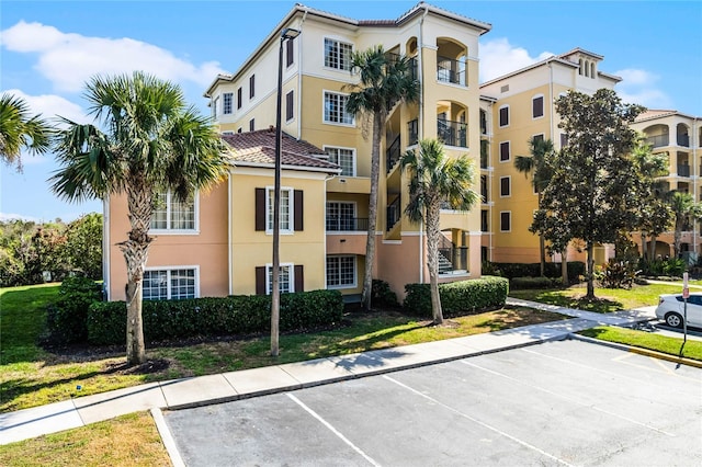 view of property featuring uncovered parking