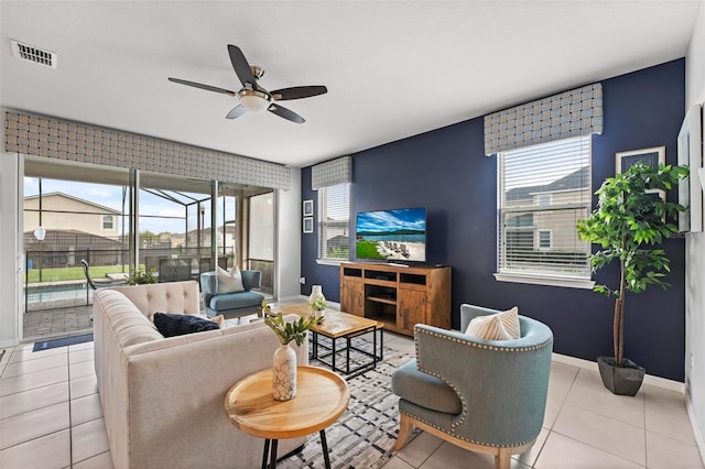 tiled living room featuring a wealth of natural light and ceiling fan